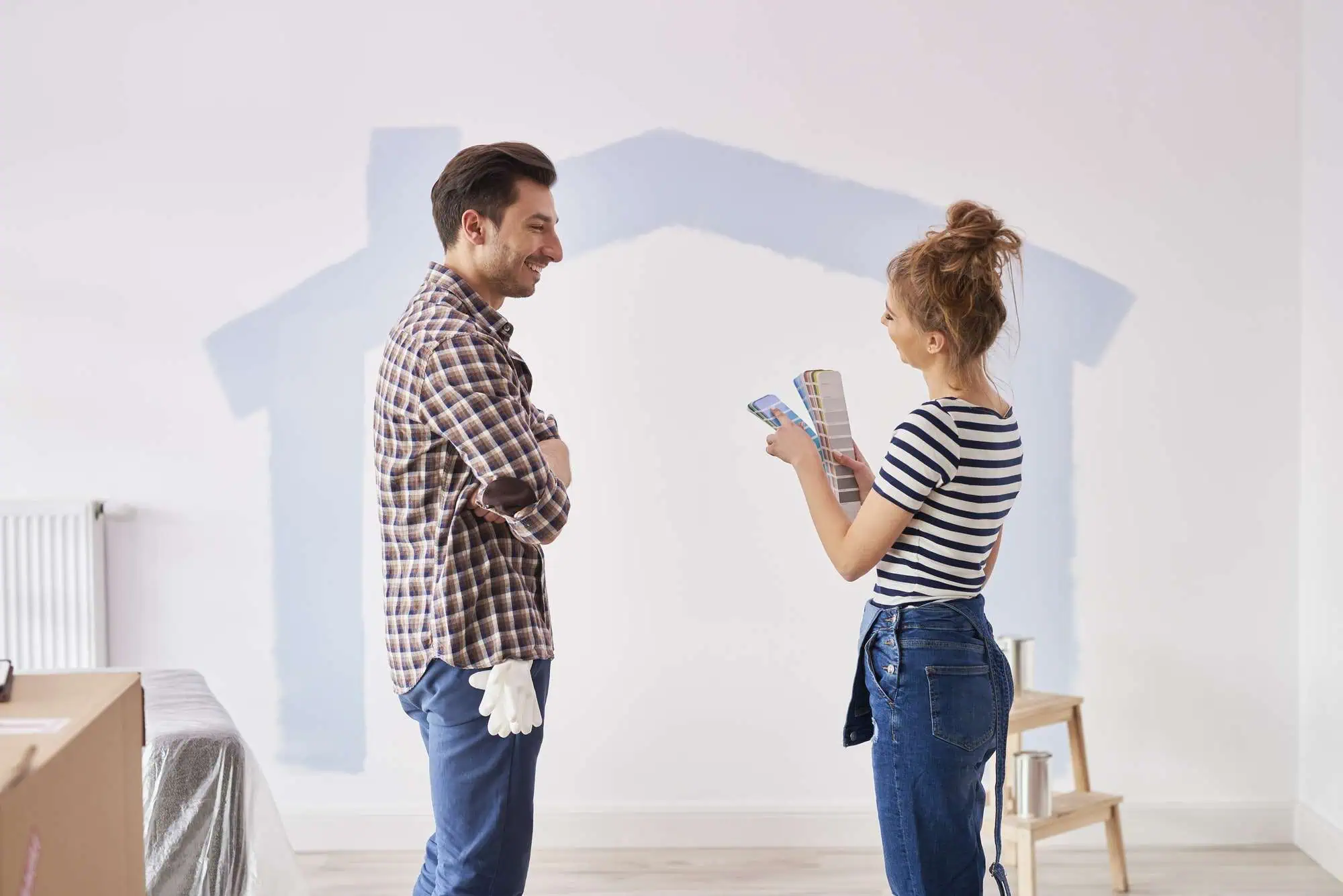 Interior painting consultation with a professional painter and a homeowner discussing color options.